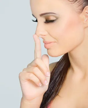 woman pointing to her nose
